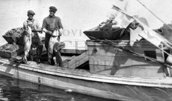 Fishing crew showing off lake trout catch in the early...