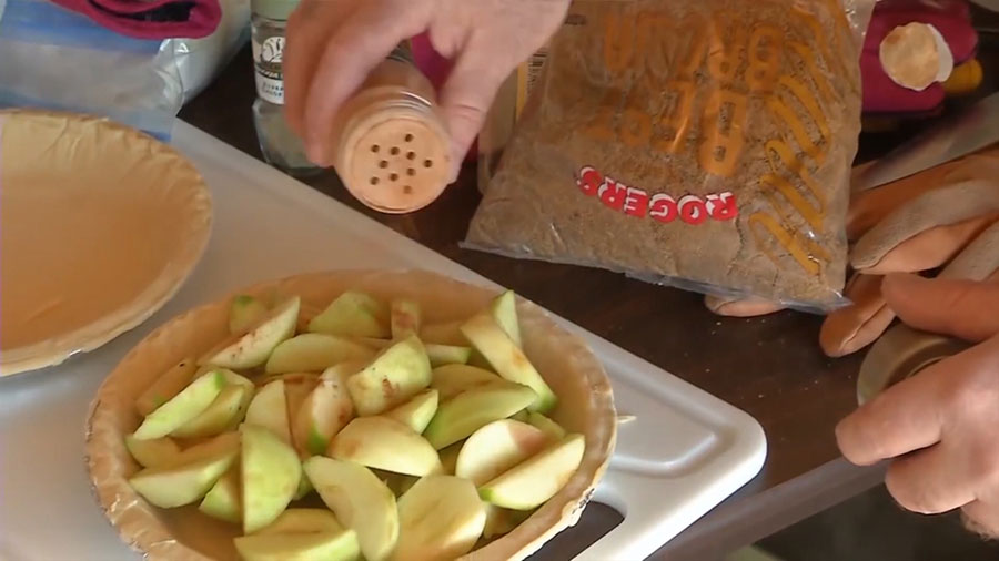 Preparing an apple pie for the dutch oven